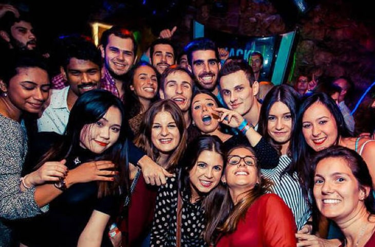 Group of young people on a pub crawl in Krakow together in a bar 